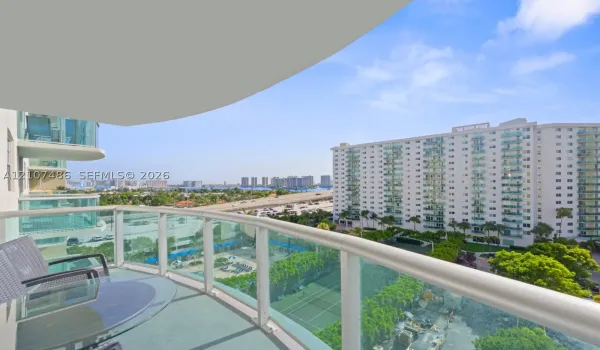 Private balcony featuring glass panel railing and concrete flooring