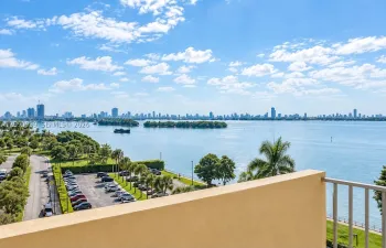 Elevated terrace featuring a metal railing with a panoramic waterfront and cityscape horizon