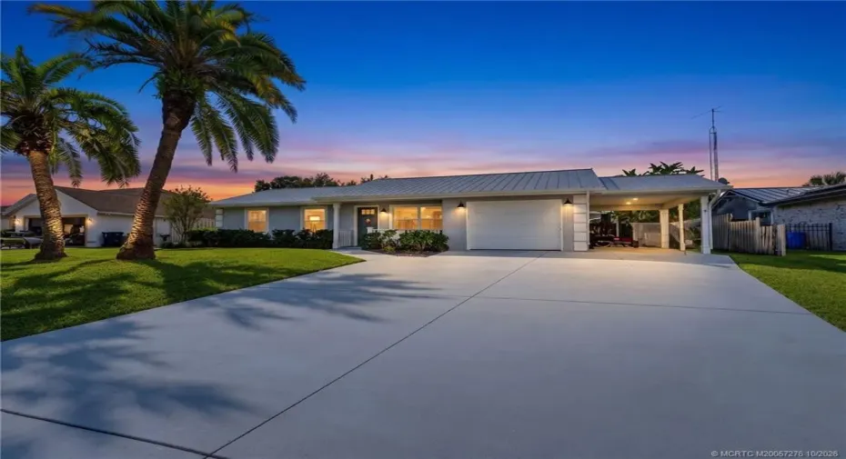 Home Sweet Home. Charming coastal style, a metal roof, and convenient garage and carport parking.