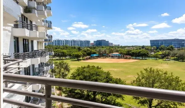 Elevated private balcony featuring metal railings and unobstructed exposure to the surrounding parkland, expansive green space, and mature trees