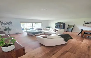 Interior space featuring wood-finish flooring, recessed lighting, and a sliding glass door providing exterior access