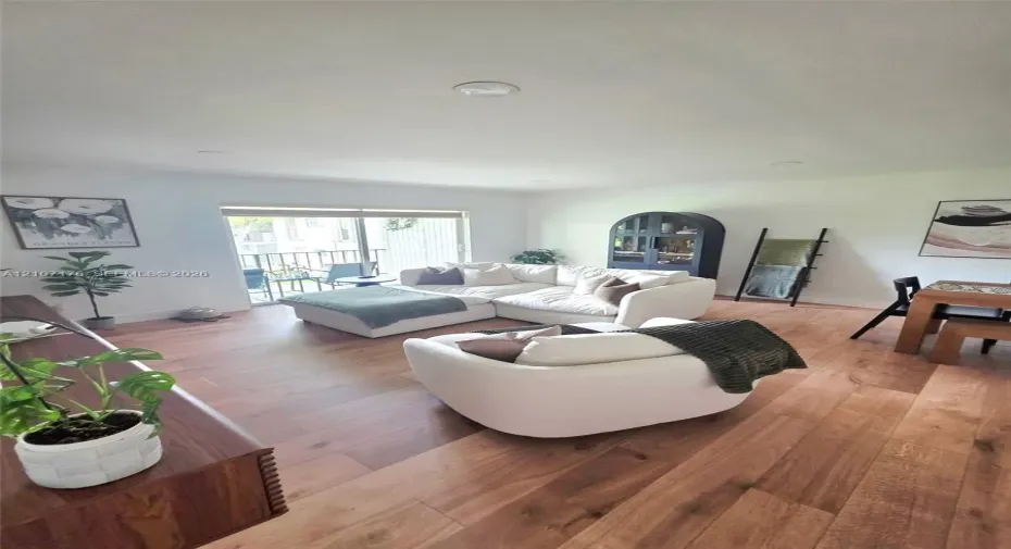 Interior space featuring wood-finish flooring, recessed lighting, and a sliding glass door providing exterior access