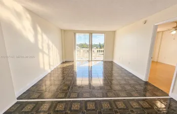 Interior space featuring patterned tile flooring and sliding glass doors leading to an exterior balcony