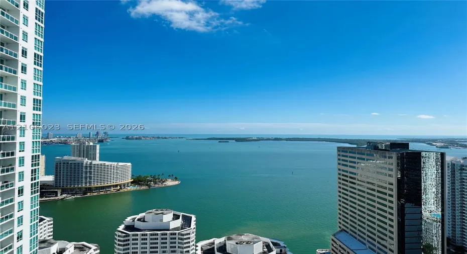 Expansive waterfront vista overlooking Biscayne Bay with turquoise waters and distant skyline