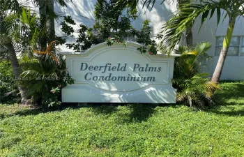 Custom-built masonry monument sign featuring embossed lettering and professional landscape planting