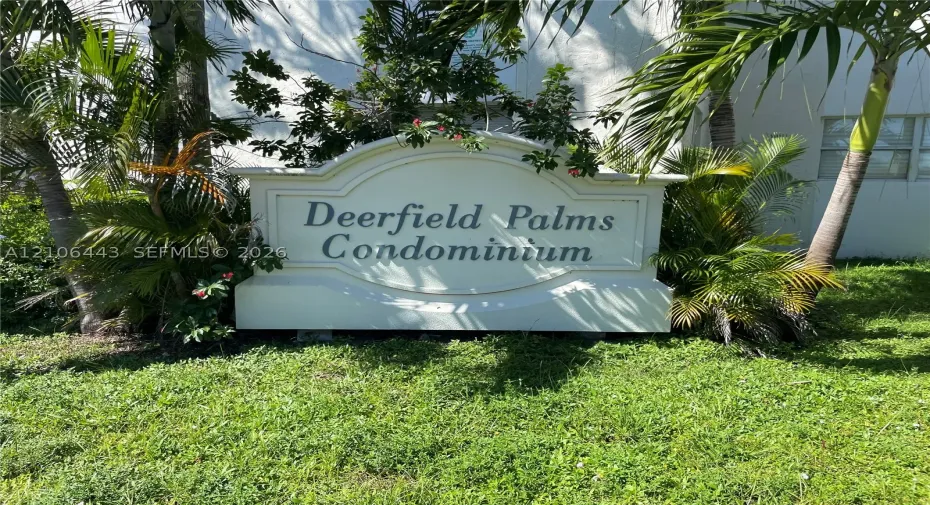 Custom-built masonry monument sign featuring embossed lettering and professional landscape planting