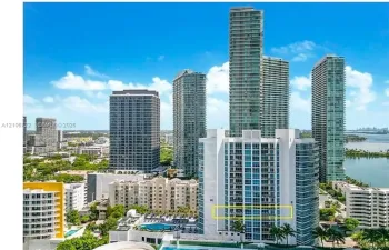 High-rise residential building featuring floor-to-ceiling glass windows and private balconies
