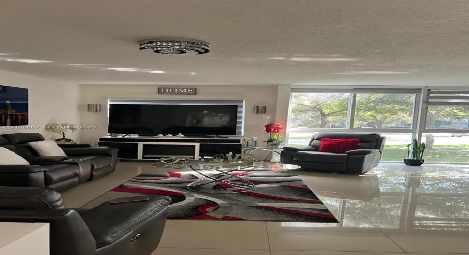 Polished tile flooring, floor-to-ceiling windows, and decorative chrome-finish flush mount lighting