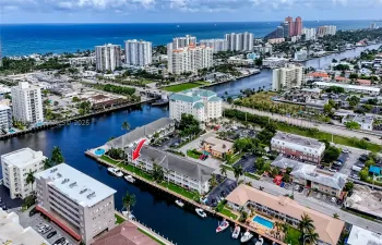 Aerial perspective of multi-story building featuring deep-water canal access, private boat slips, and coastal proximity