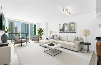 Living area featuring floor-to-ceiling windows, access to a private balcony, flooring, and multi-bulb track lighting - Virtually staged.