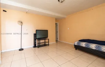 Light-toned ceramic tile flooring and ceiling-mounted lighting fixture