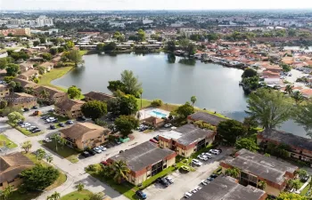 Aerial perspective of the community featuring a central lake and a shared swimming pool