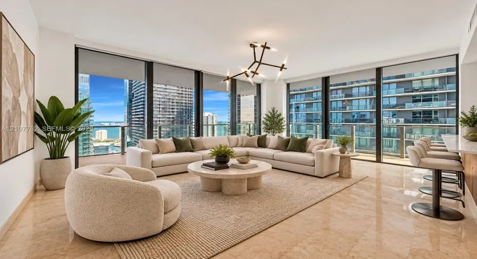 Floor-to-ceiling windows, polished stone flooring, custom multi-arm statement lighting, and a breakfast bar
