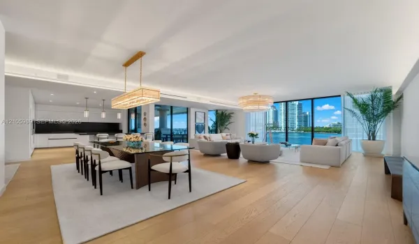 Open-concept living space featuring wood-finish flooring, floor-to-ceiling windows, recessed lighting, and a modern linear chandelier