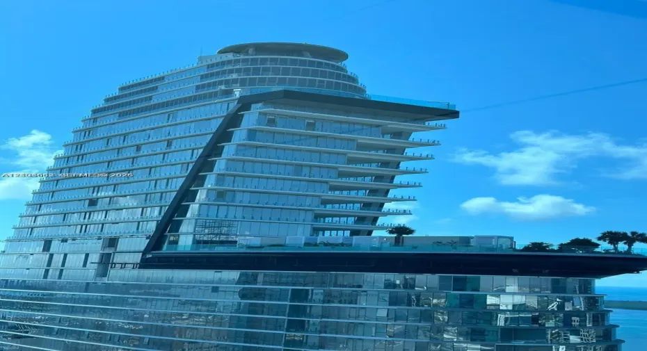 Contemporary high-rise architecture featuring a glass curtain wall, cantilevered design, multi-level terraces, and integrated rooftop landscape elements