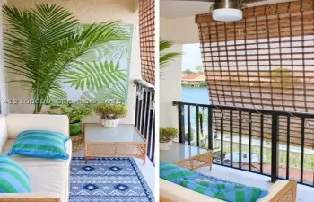 Covered balcony featuring black metal railings, a ceiling-mounted light fixture, and textured wall finish