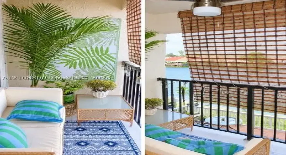 Covered balcony featuring black metal railings, a ceiling-mounted light fixture, and textured wall finish