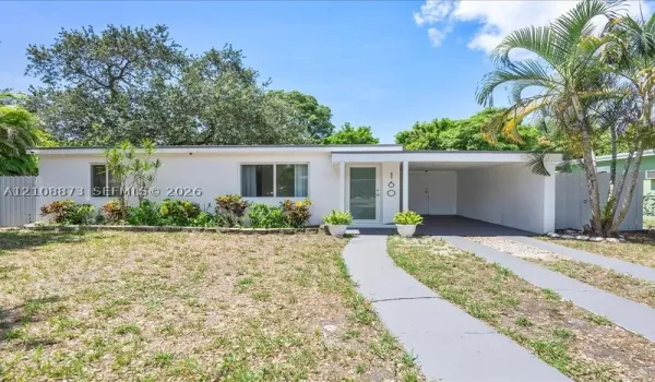 Single-story residence featuring a stucco exterior, attached carport, concrete driveway, and mature landscaping