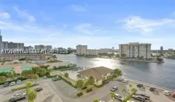 High-rise perspective featuring panoramic water frontage, palm landscaping, and urban skyline horizon
