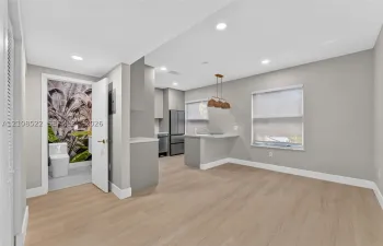 Kitchen featuring wood-finish flooring, recessed lighting, a breakfast bar, and stainless steel appliances