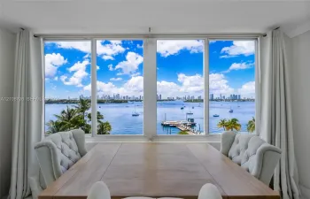 Large format picture windows featuring expansive water, marina, and skyline scenes