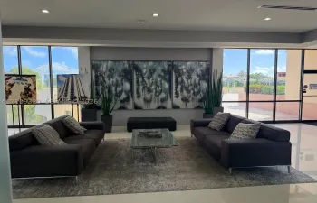 Common area featuring floor-to-ceiling windows, polished tile flooring, and recessed lighting