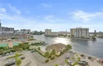 High-rise perspective featuring panoramic water frontage, palm landscaping, and urban skyline horizon