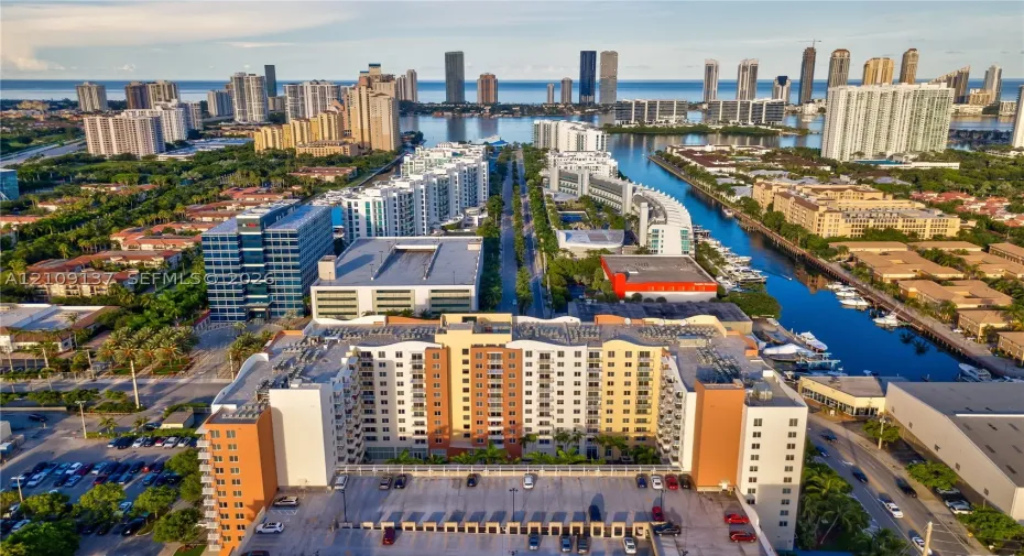 Multi-story high-rise building featuring a structured parking facility, concrete facade, and integrated balconies