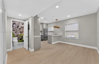 Kitchen featuring wood-finish flooring, recessed lighting, a breakfast bar, and stainless steel appliances
