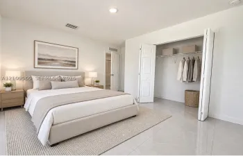 Neutral-toned ceramic tile flooring, recessed ceiling lighting, and a bi-fold closet door with integrated wire shelving
