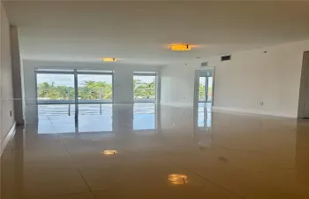 Large-format tile flooring, sliding glass doors, and flush-mount ceiling lighting