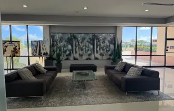 Common area featuring floor-to-ceiling windows, polished tile flooring, and recessed lighting