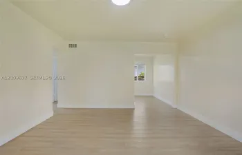 Neutral interior featuring wood-finish flooring, smooth wall surfaces, and a ceiling-mounted light fixture
