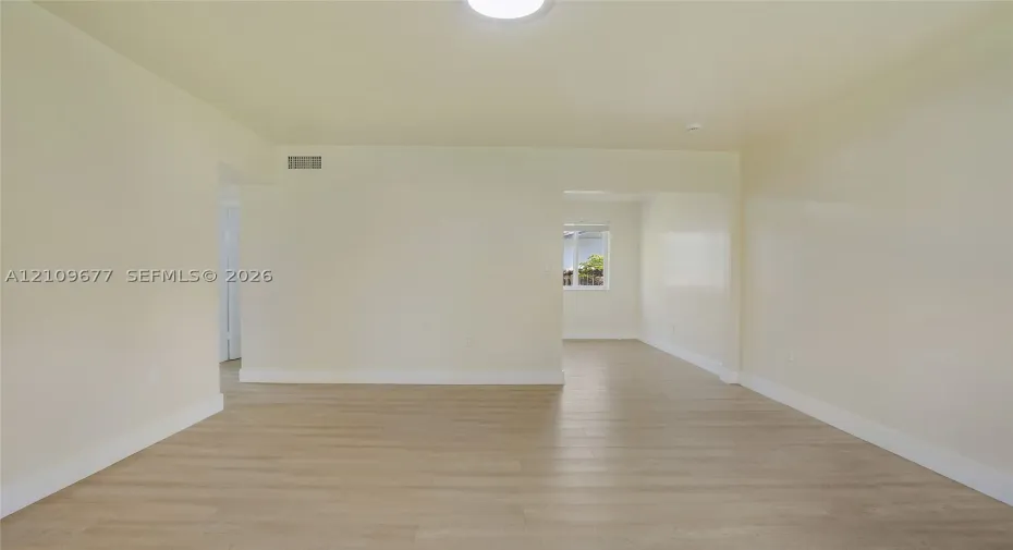 Neutral interior featuring wood-finish flooring, smooth wall surfaces, and a ceiling-mounted light fixture