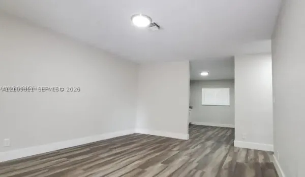 Interior featuring wood-finish flooring, neutral wall paint, and recessed lighting