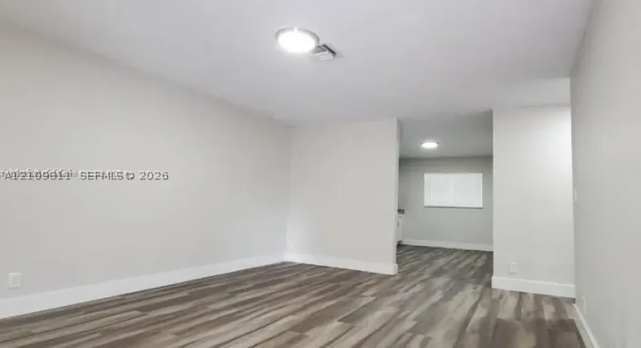 Interior featuring wood-finish flooring, neutral wall paint, and recessed lighting