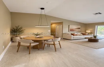 Vaulted ceilings, large-format tile flooring, circular modern pendant lighting, and sliding glass door