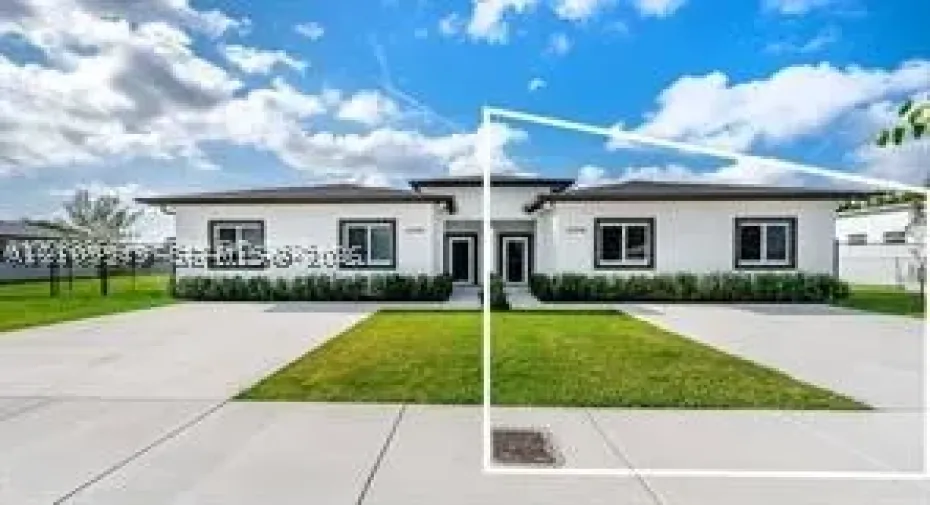 Contemporary exterior featuring a white stucco facade, dark trim, concrete driveway, and a front lawn