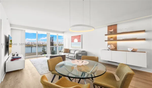 Open-concept living space featuring floor-to-ceiling windows, wood-finish flooring, modern circular LED integrated lighting built into custom soffits, and built-in floating wall shelving with integrated LED lighting