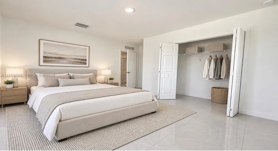Neutral-toned ceramic tile flooring, recessed ceiling lighting, and a bi-fold closet door with integrated wire shelving
