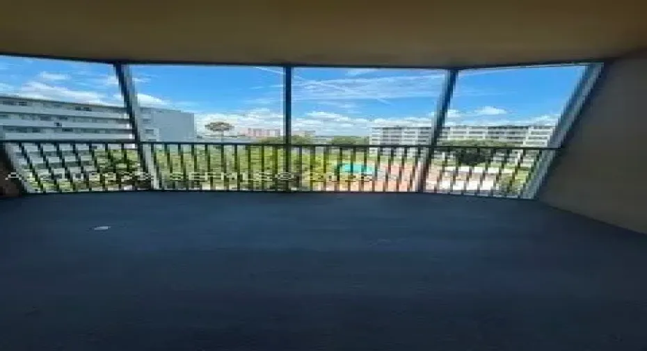 Covered balcony featuring multi-panel glass enclosures and metal railings
