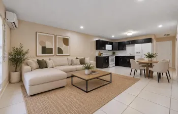 Open-concept interior featuring dark-toned cabinetry, ceramic tile flooring, recessed lighting, and a wall-mounted ductless climate control unit