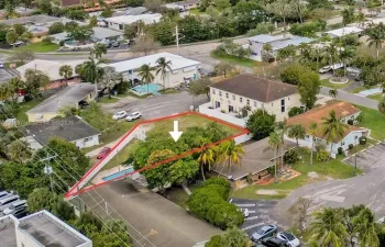 Corner lot featuring mature trees, established palms, and a private swimming pool