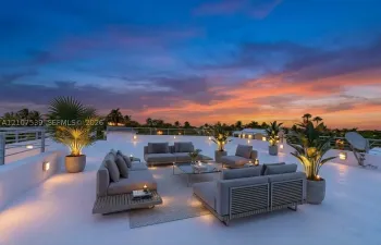 Expansive rooftop terrace featuring a smooth-finish deck, metal perimeter railing, and integrated wall-mounted lighting