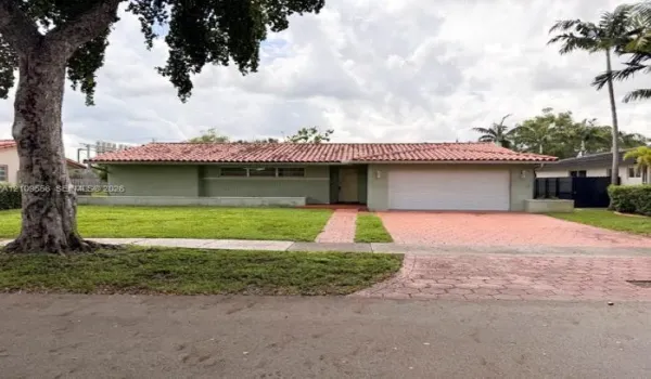 Single-story exterior featuring a clay tile roof, horizontal siding, an attached two-car garage, and a paver driveway
