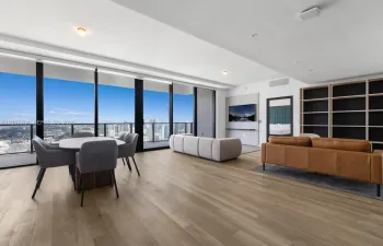 Floor-to-ceiling windows, wood-finish flooring, built-in shelving, recessed lighting, and a private balcony