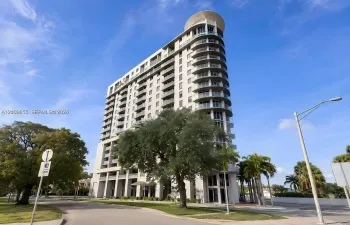 High-rise building exterior featuring a curved facade, multi-level glass-railed balconies, and a reinforced concrete structural design