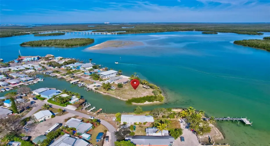 Waterfront lot situated on a peninsula featuring coastal vegetation and direct open water access