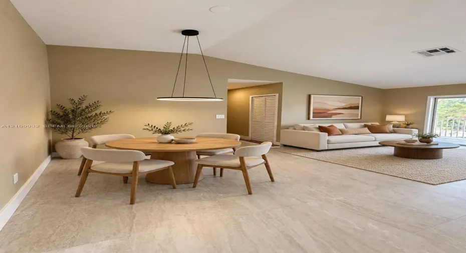 Vaulted ceilings, large-format tile flooring, circular modern pendant lighting, and sliding glass door