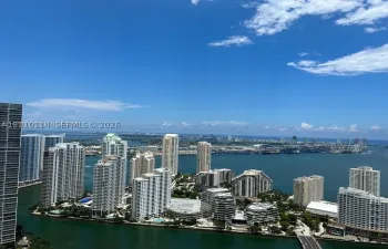 High-altitude perspective featuring expansive water frontage, coastal scenery, and a panoramic urban skyline